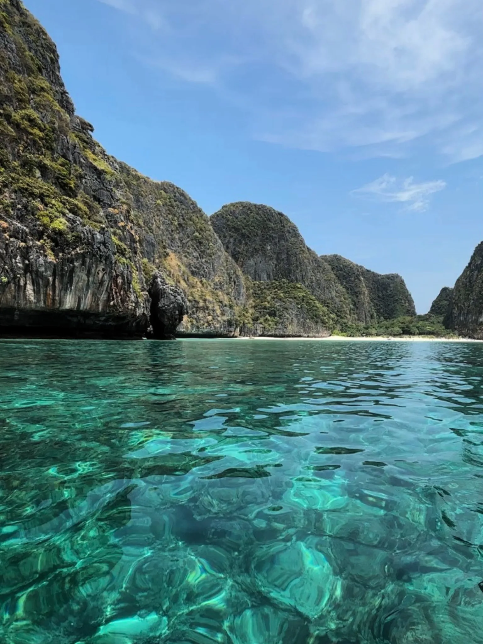 Emerald cove framed by tropical limestone cliffs