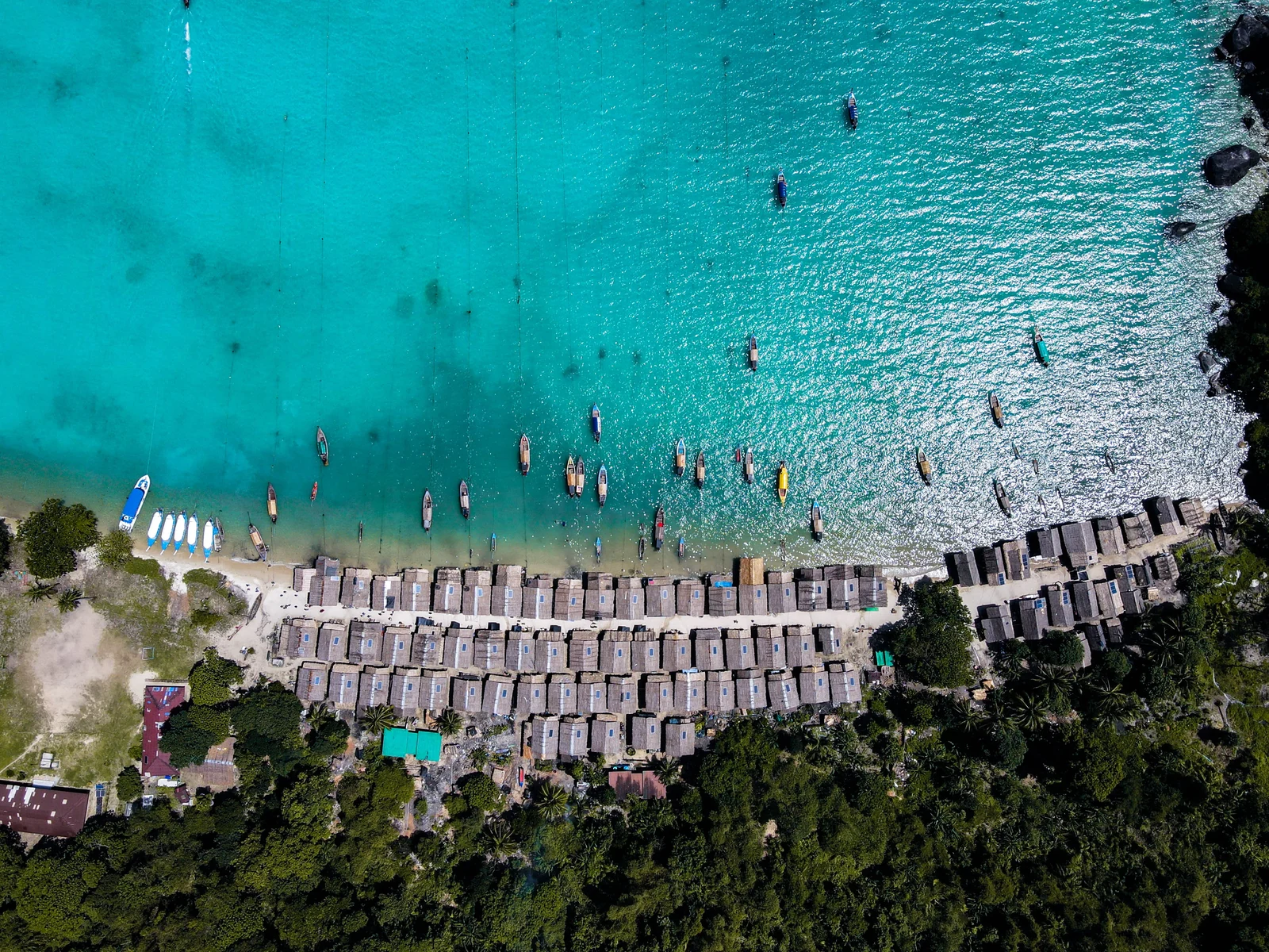 Moken boats and village over clear turquoise water